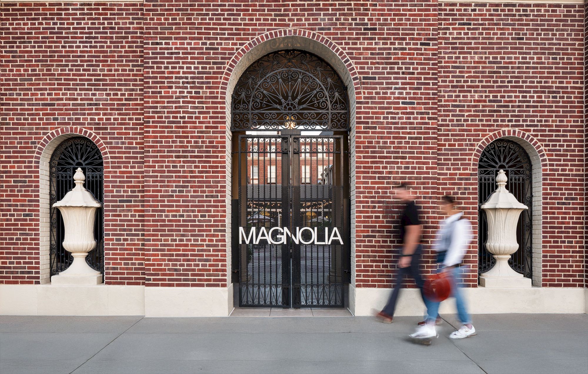 A red brick building with a gated entrance labeled 